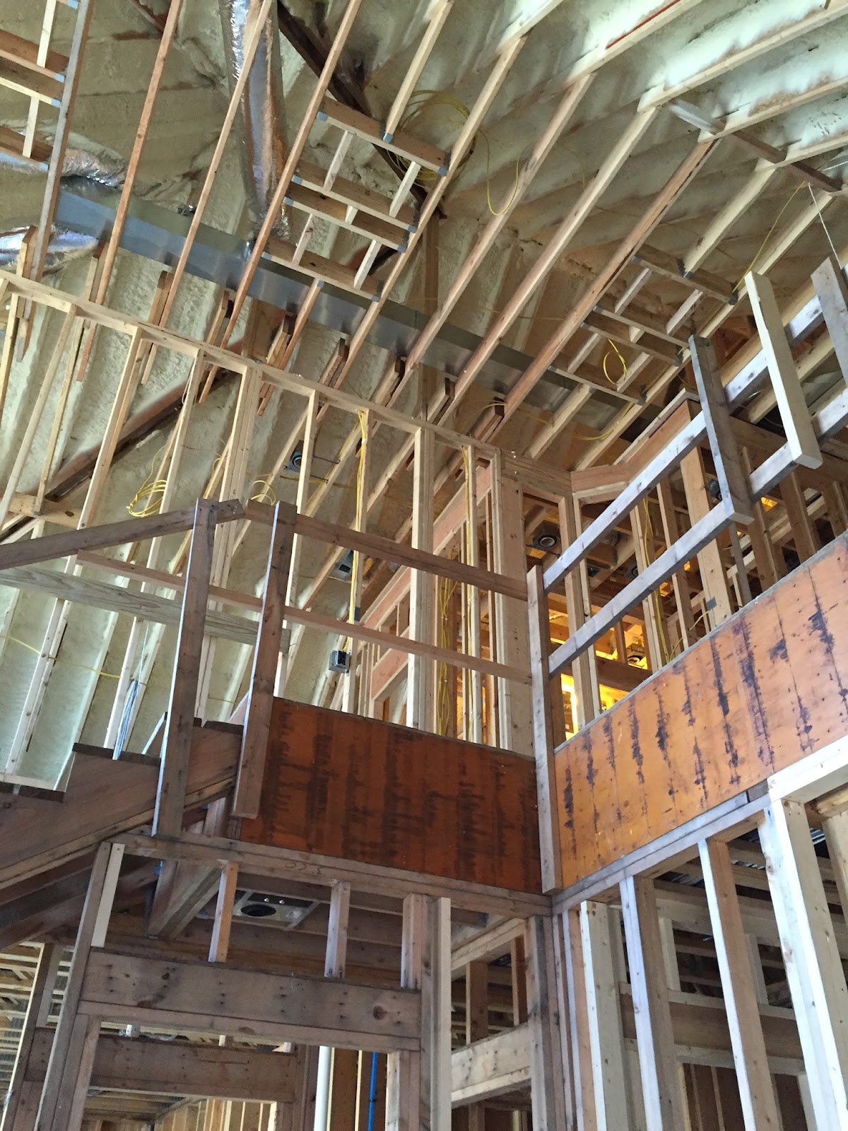 Vaulted interior framing with structural steel beam during a gut renovation